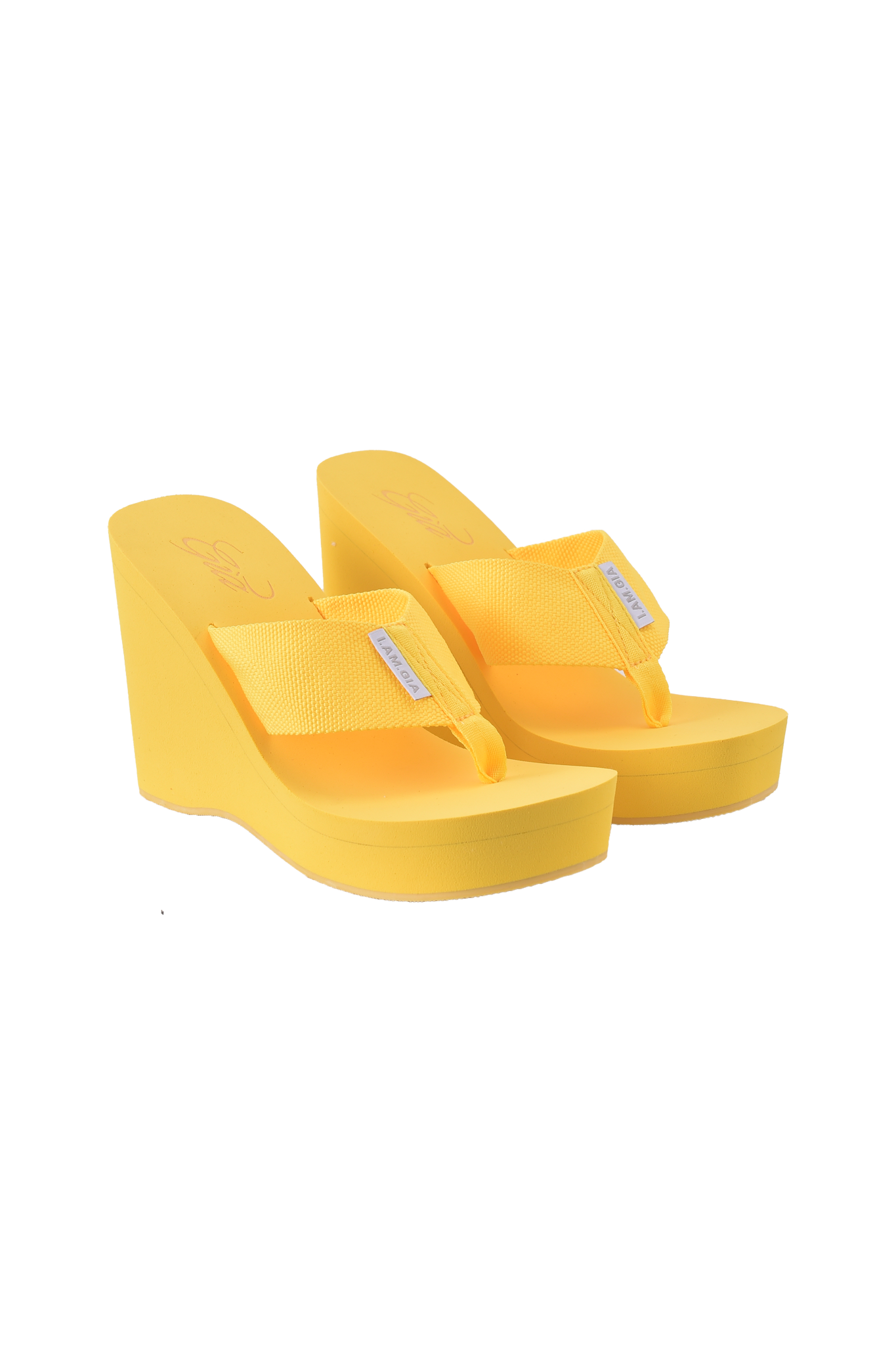 A pair of SHELBY FLIP FLOP - YELLOW sandals by I.AM.GIA featuring bright yellow wedge soles, mesh straps, and a small white label on each strap, displayed on a white background.