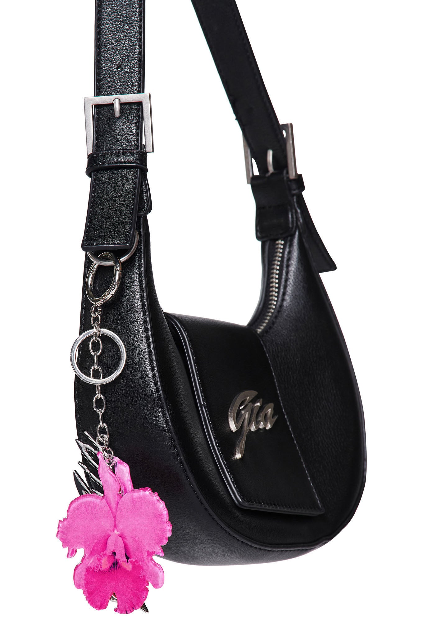 A black leather shoulder bag with silver hardware from I.AM.GIA, featuring the GIA metal logo on the front and an ORCHID KEYCHAIN - NEON PINK attached to a metal ring.