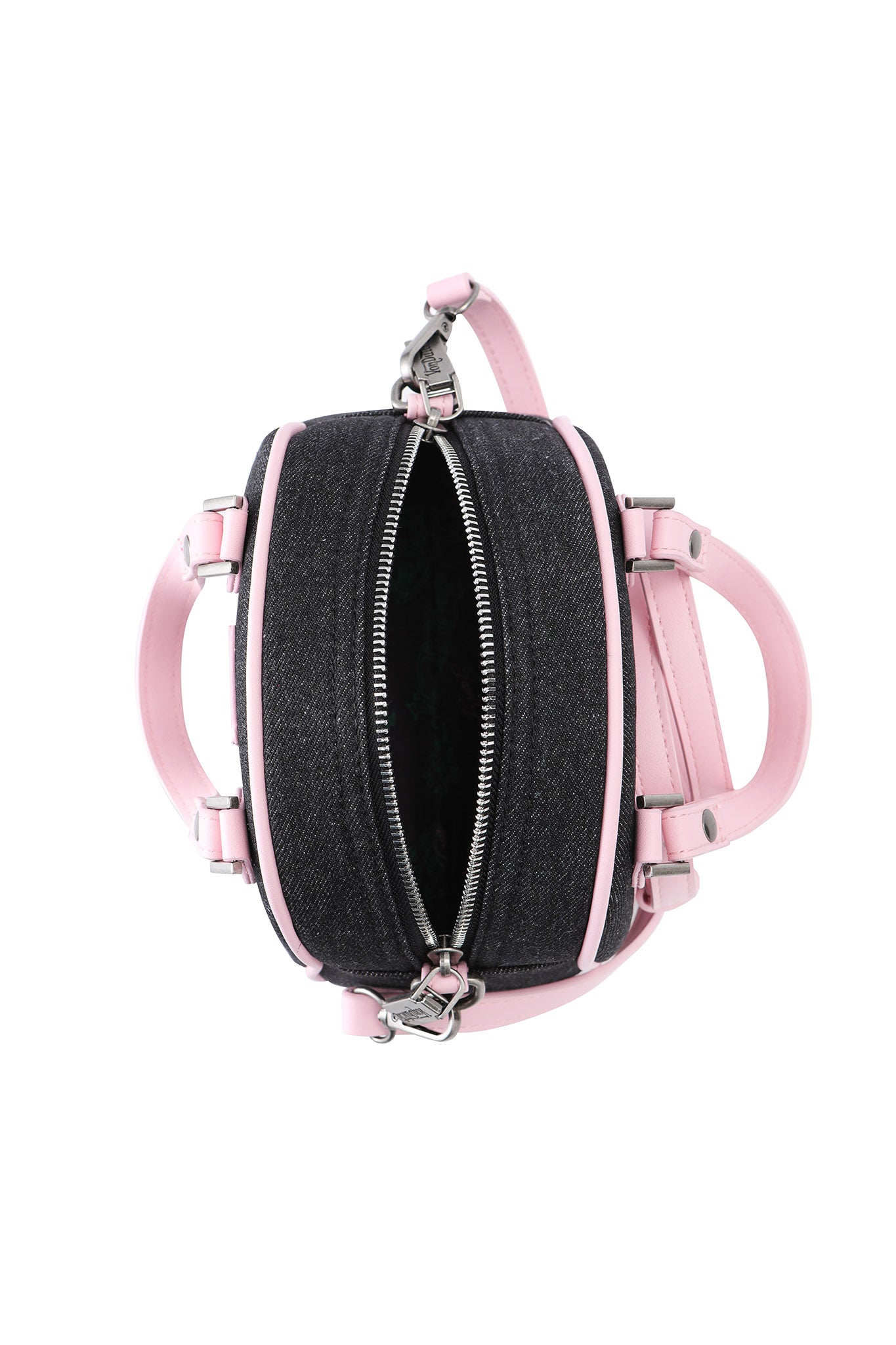 The I.AM.GIA X VON DUTCH BOWLING BAG in indigo denim features light pink leather accents, a partially open top zipper revealing the interior, and two handles, photographed against a white background.