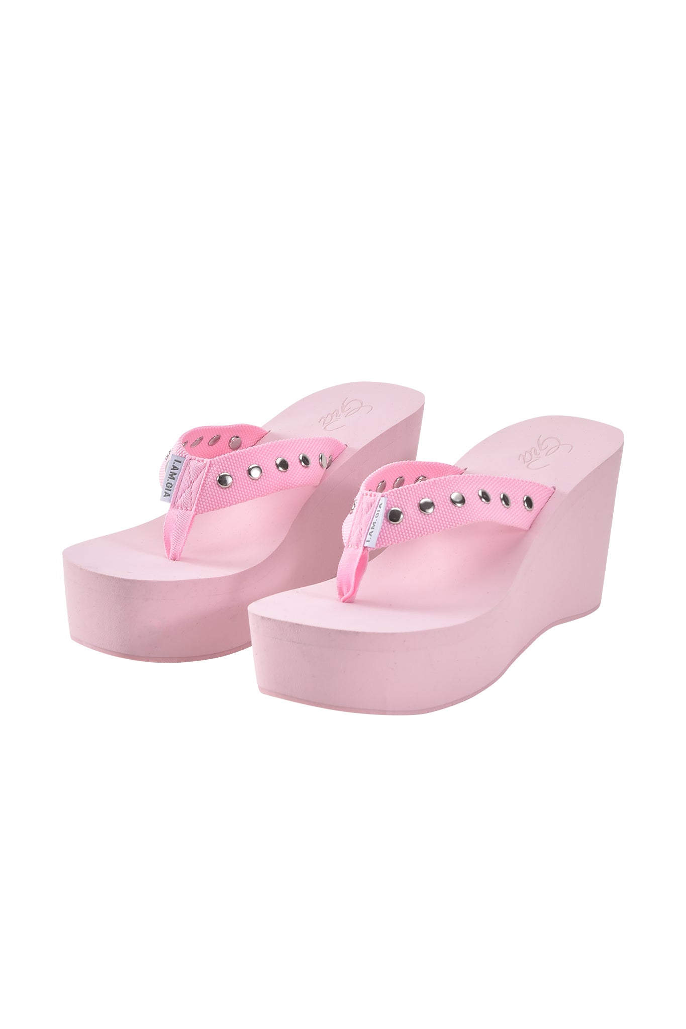 The SHELBY STUDDED FLIP FLOP 2.0 - BABY PINK by I.AM.GIA is a light pink platform sandal with fabric straps and silver studs, shown on a white background.