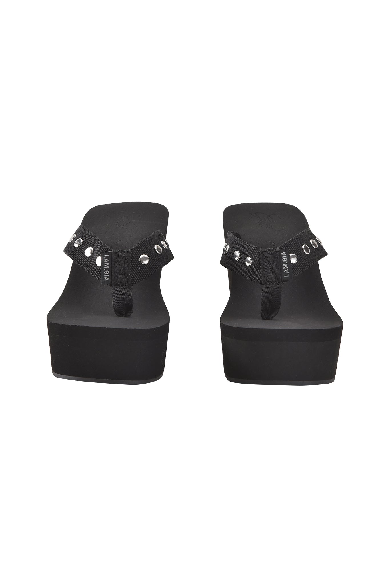 The I.AM.GIA SHELBY STUDDED FLIP FLOP 2.0 in black, featuring thick platform soles and studded straps, is displayed from the back against a plain white background.