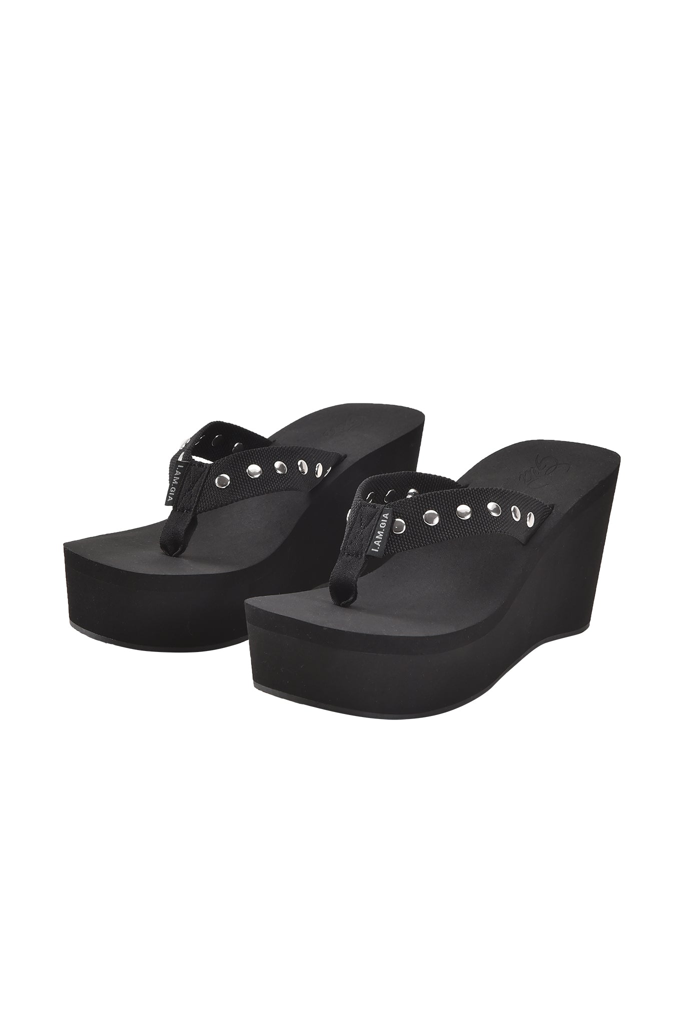The I.AM.GIA SHELBY STUDDED FLIP FLOP 2.0 in black features thick soles and decorative silver studs on the straps, shown against a white background.