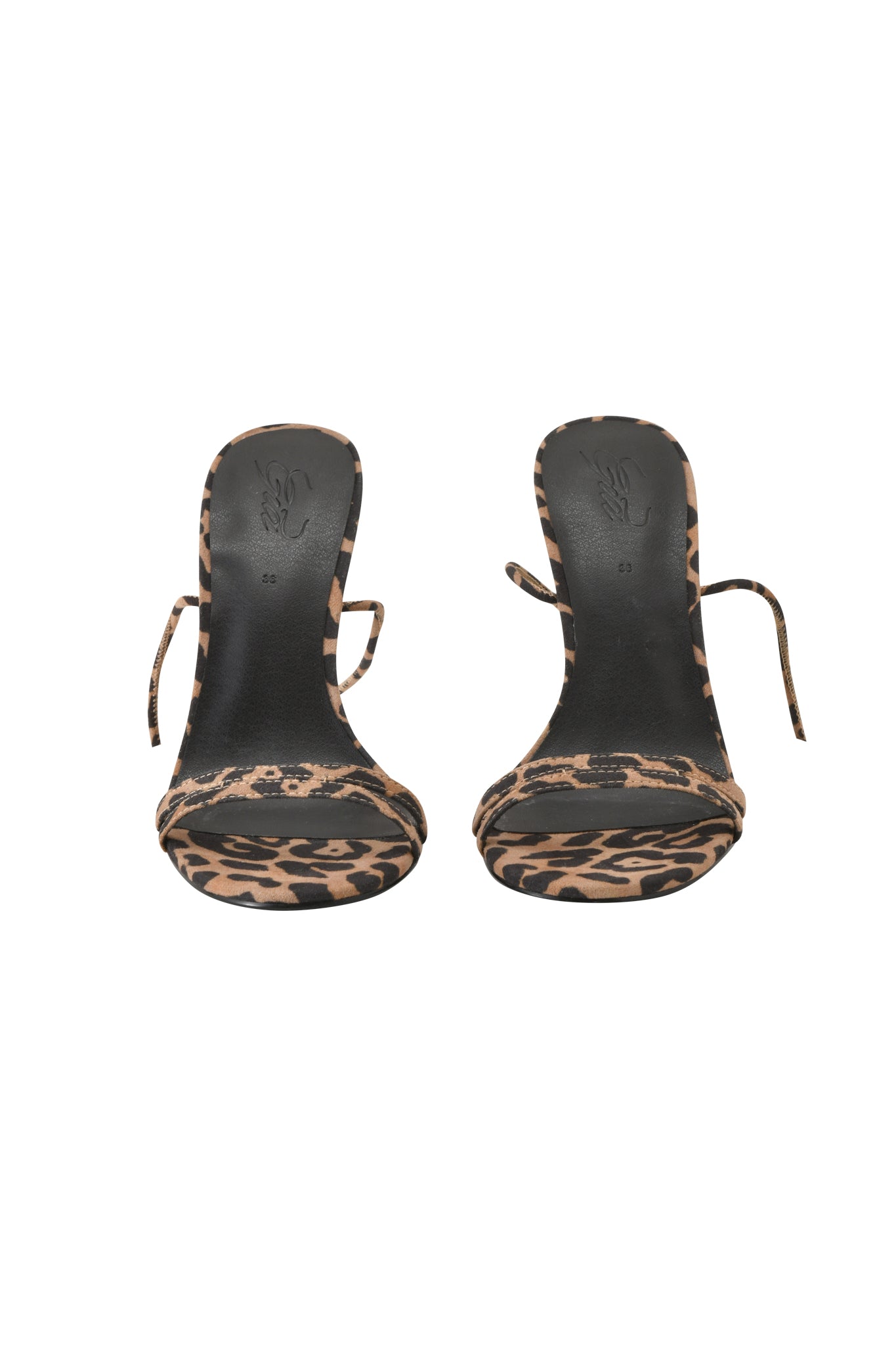 The SCARLETTE HEEL - LEOPARD by I.AM.GIA features strappy stiletto high-heeled sandals with a black and tan leopard print heel and slim ankle straps, shown from the front on a white background.