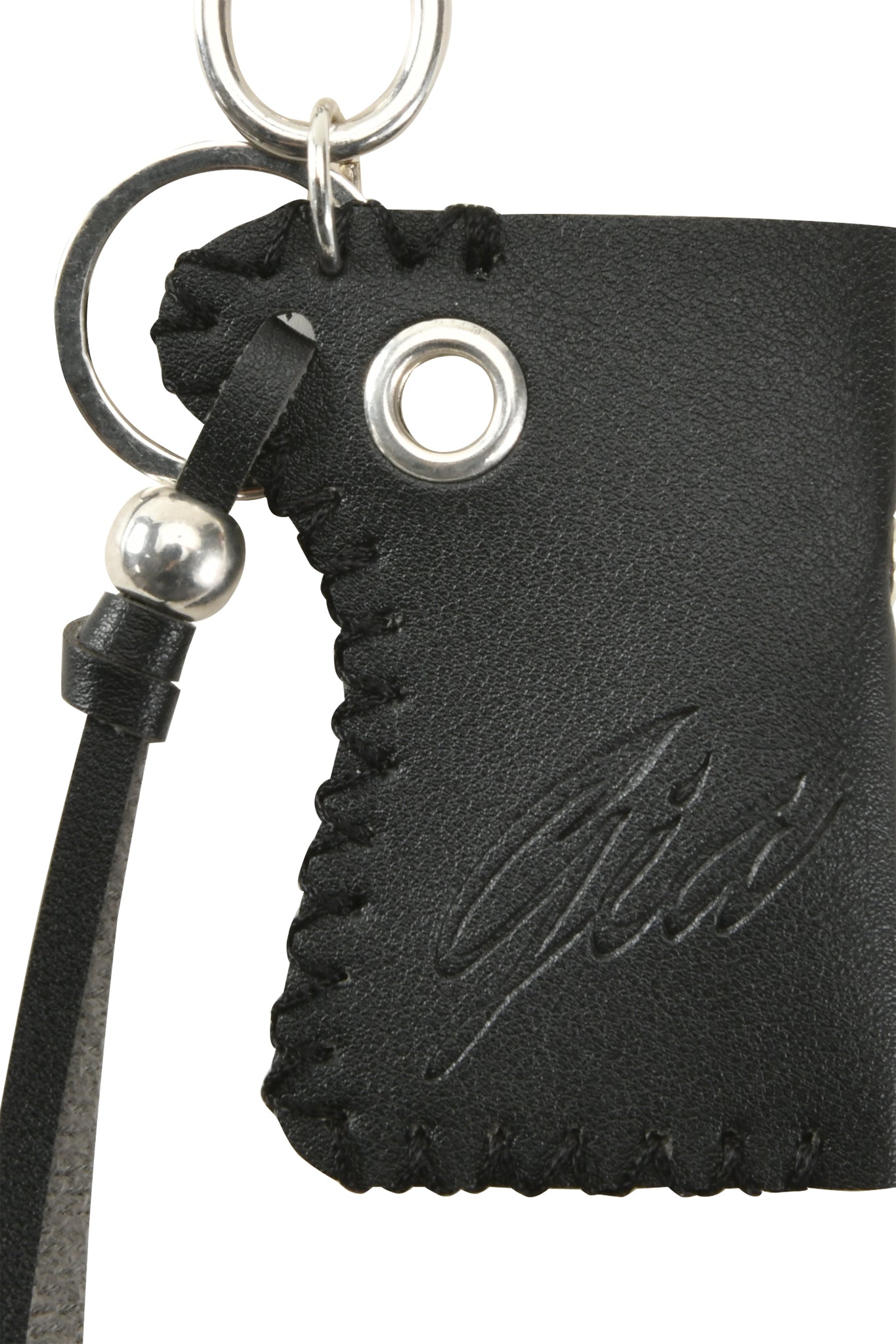 Close-up of the VENUS LIGHTER KEYCHAIN - BLACK by I.AM.GIA, featuring black leather with stitched edges, a metal grommet, silver bead on the strap, engraved script design, and the GIA logo.