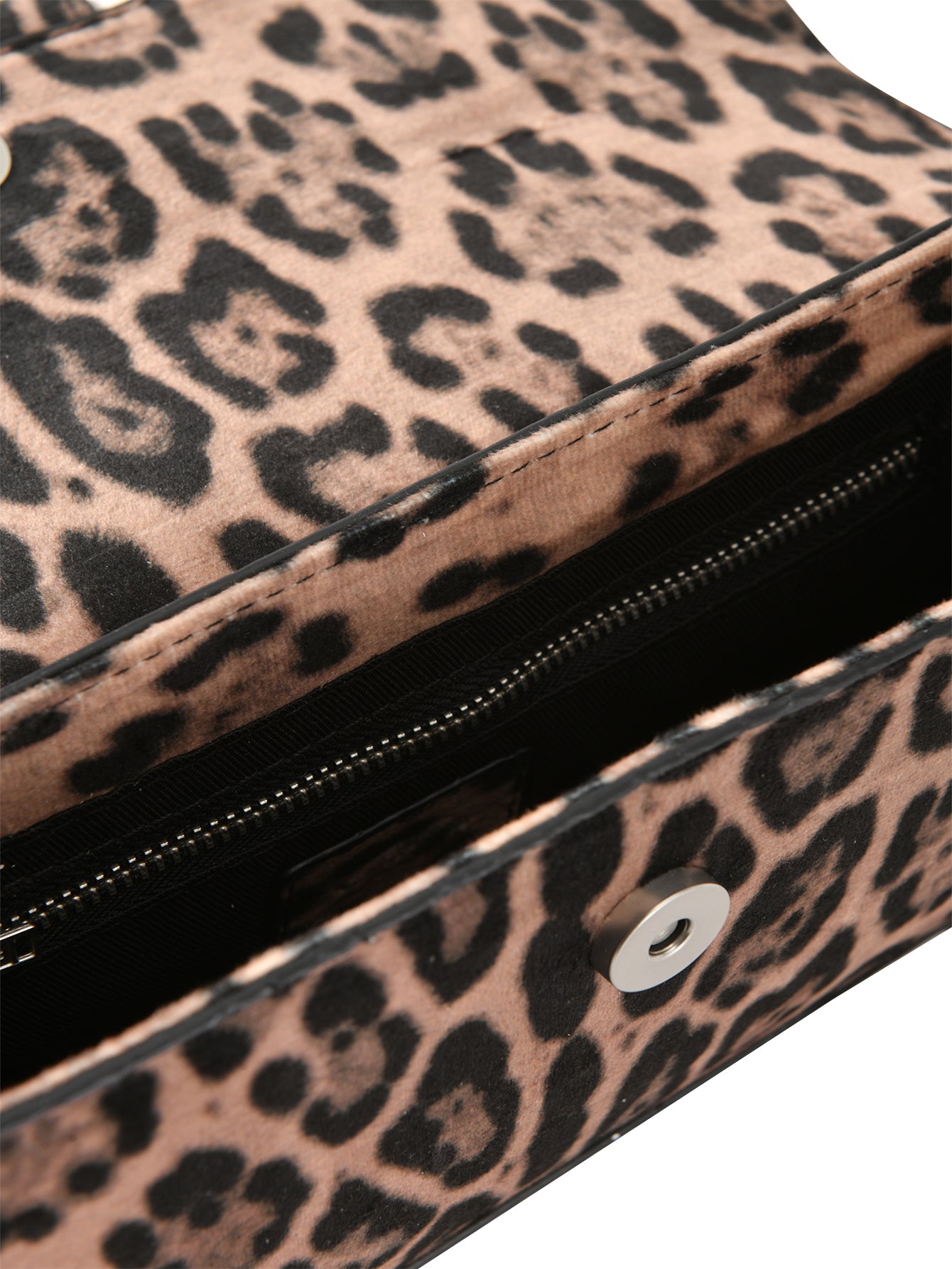Close-up of the I.AM.GIA MILA BAG - PANTHERA, an open cheetah print mini purse with a black interior, zippered pocket, and magnetic snap closure on the flap.