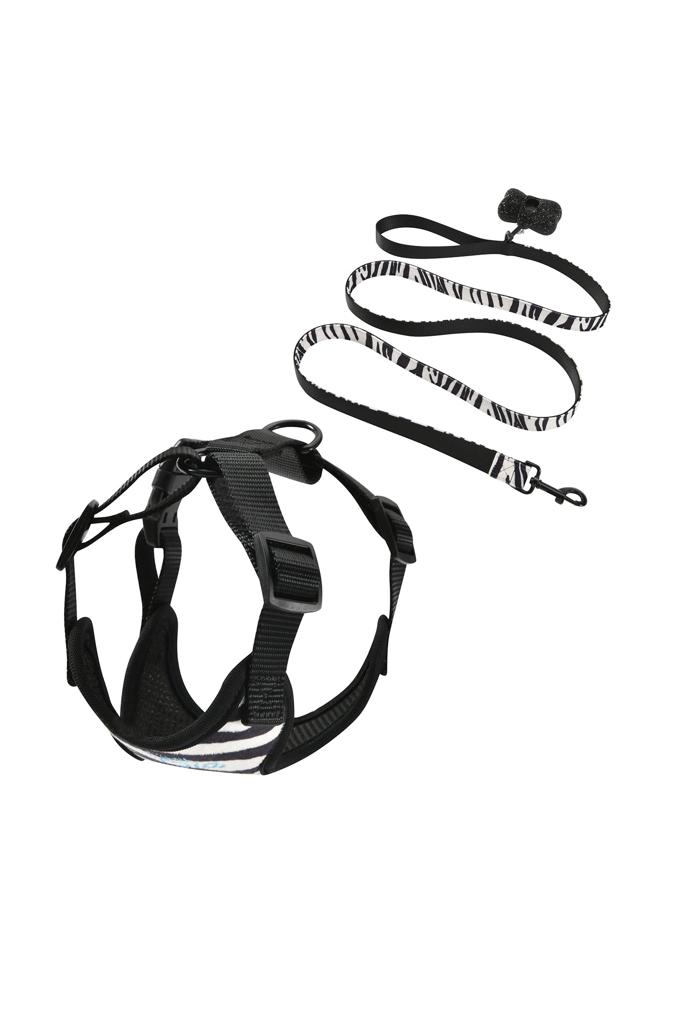 The STAR PAWFECT 3-PIECE SET - FINE LINE ZEBRA by I.AM.GIA is displayed, combining style and functionality. This adjustable dog harness features fine-line zebra stripes paired with black straps and sturdy buckles for a secure, comfortable fit. The matching leash includes a reliable clasp and a small black accessory near the handle, making this I.AM.GIA set a fashionable favorite among zebra-patterned pet harness enthusiasts.