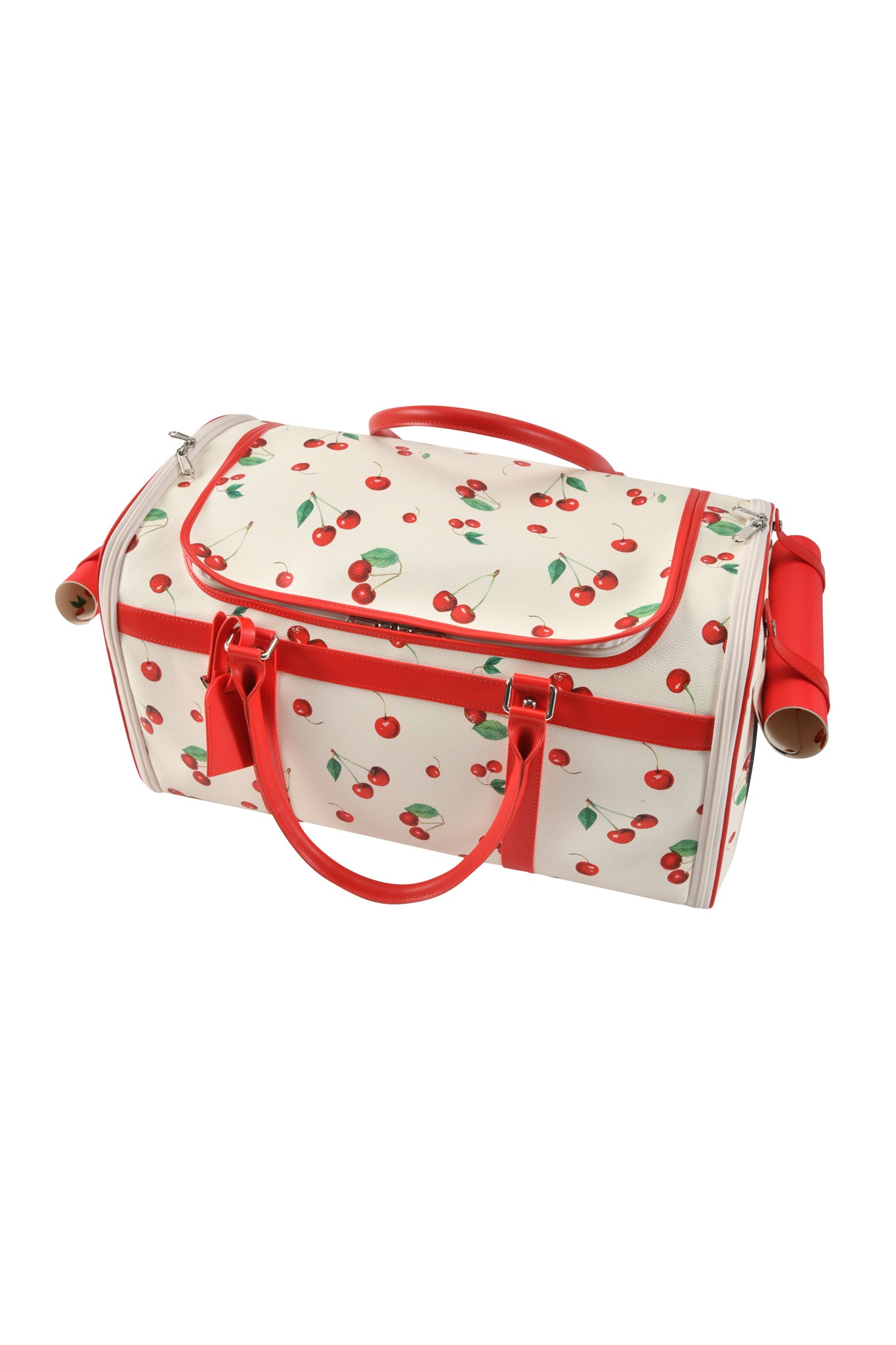 The TRIXX PET CARRIER - CHERRY ON TOP by I.AM.GIA is a white duffel-style pet carrier with red handles, trim, zippered top flap, side pockets, and rolled yoga mats at each end in the playful Cherry on Top print.