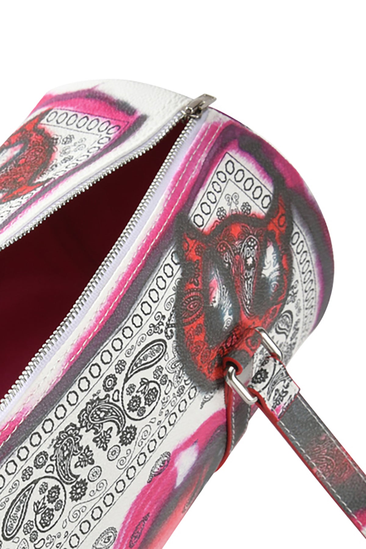A close-up of the T-REX BARREL BAG - PAISLEY FACE by I.AM.GIA, featuring black and pink paisley faux leather, a silver zipper, matching strap, and dark pink interior lining.