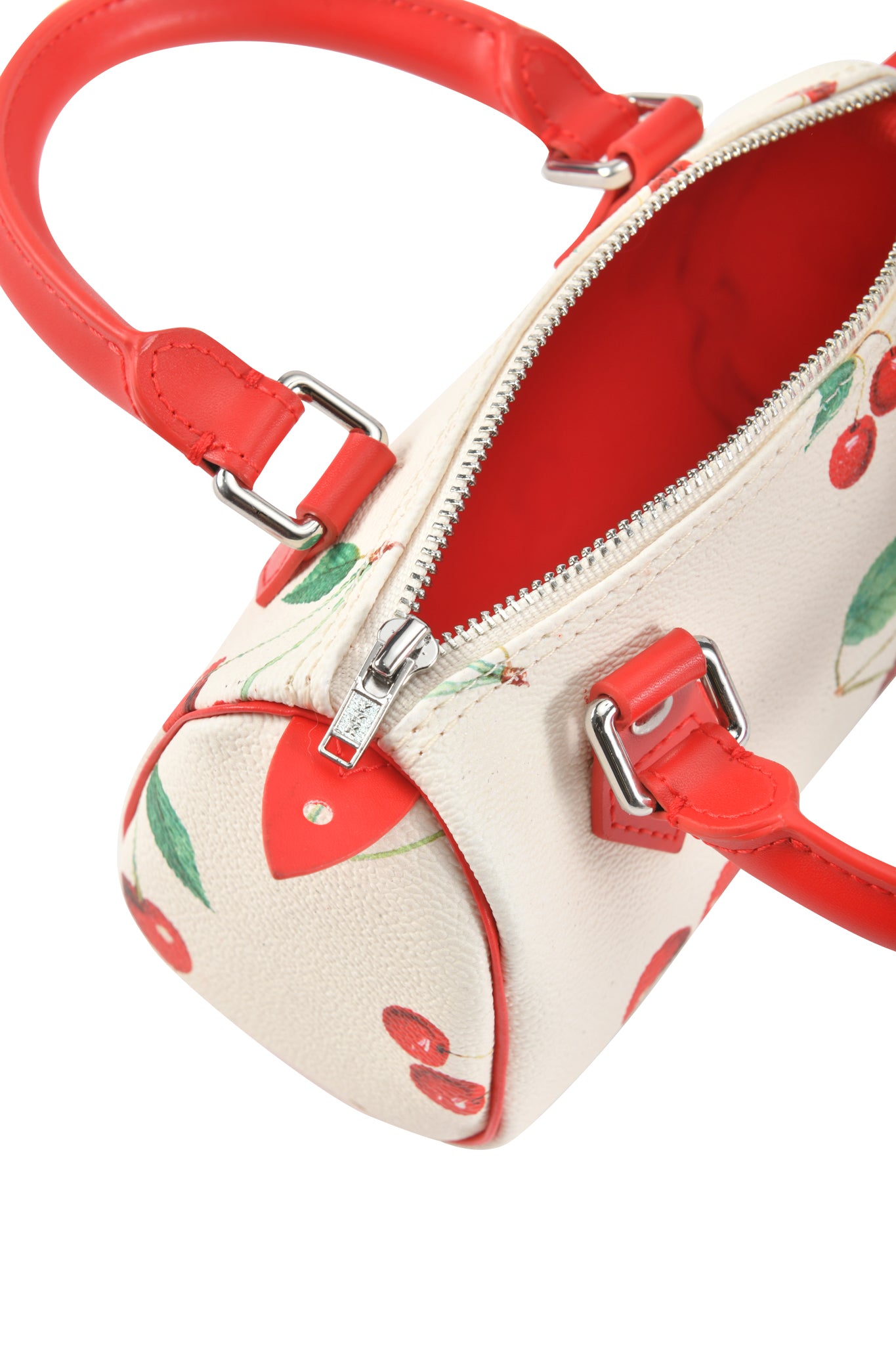 The I.AM.GIA NIKA MINI BAG - CHERRY ON TOP features a small white barrel silhouette with red handles, silver zipper, cherry print, and a bright red interior for a playful touch.
