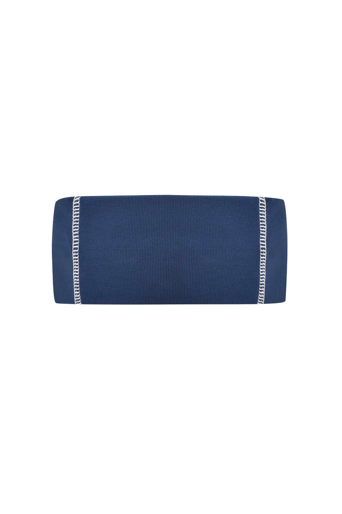 The NOVIA SPORT HEADBAND - NAVY by I.AM.GIA, a navy blue cylindrical headband with white edge stitching and a sporty look, is shown from the side against a plain white background.