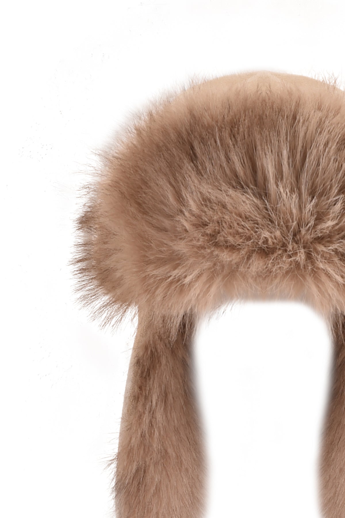 The GENA FAUX FUR TRAPPER HAT - TAN SUEDE by I.AM.GIA, a fluffy, light brown reversible trapper hat with ear flaps, is photographed against a white background.