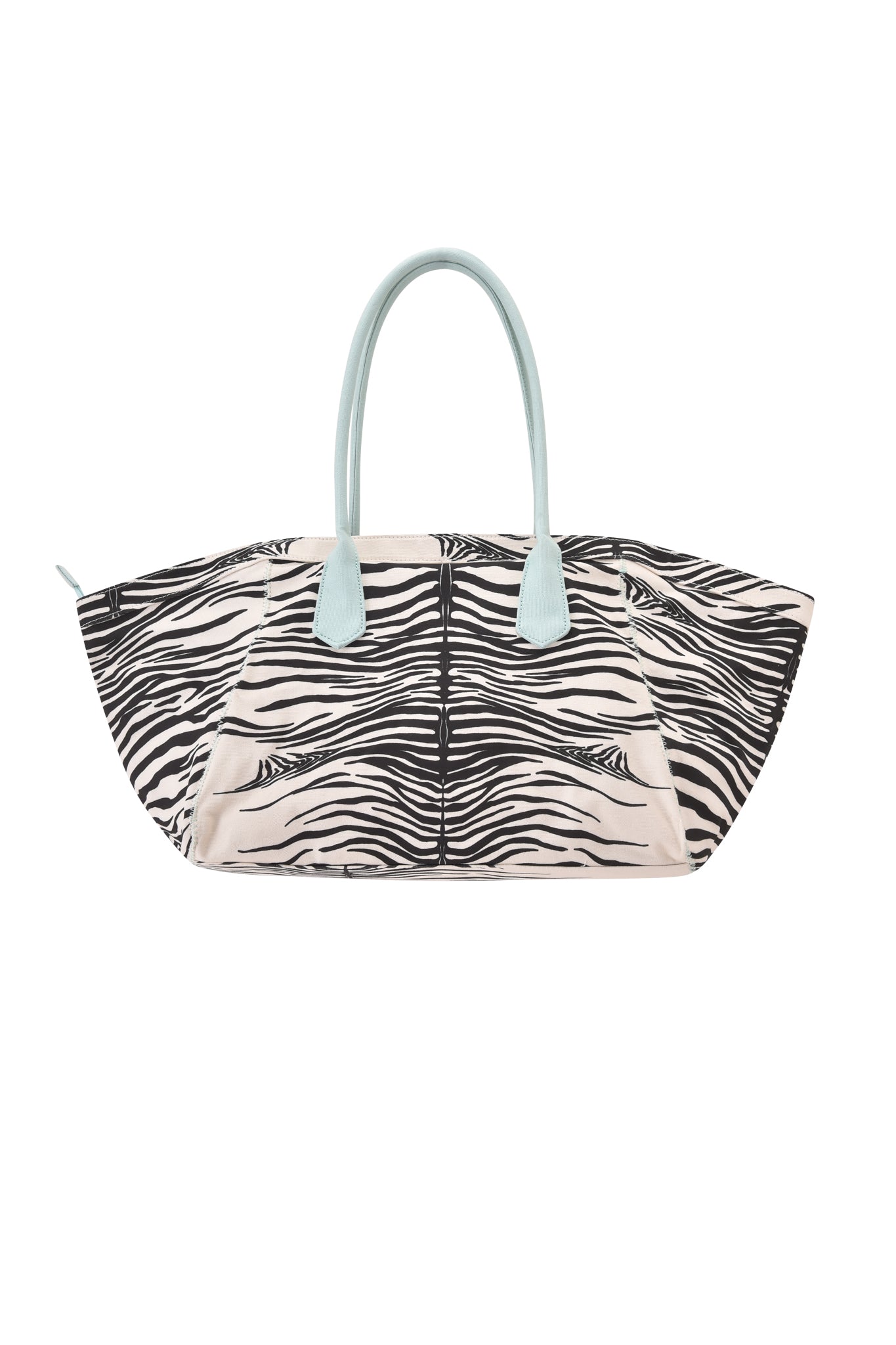 The BLARE TOTE BAG - FINE LINE ZEBRA by I.AM.GIA is a large, oversized shopper tote showcasing a bold black and white zebra print pattern, complemented by light blue handles and light beige side panels, displayed against a white background.