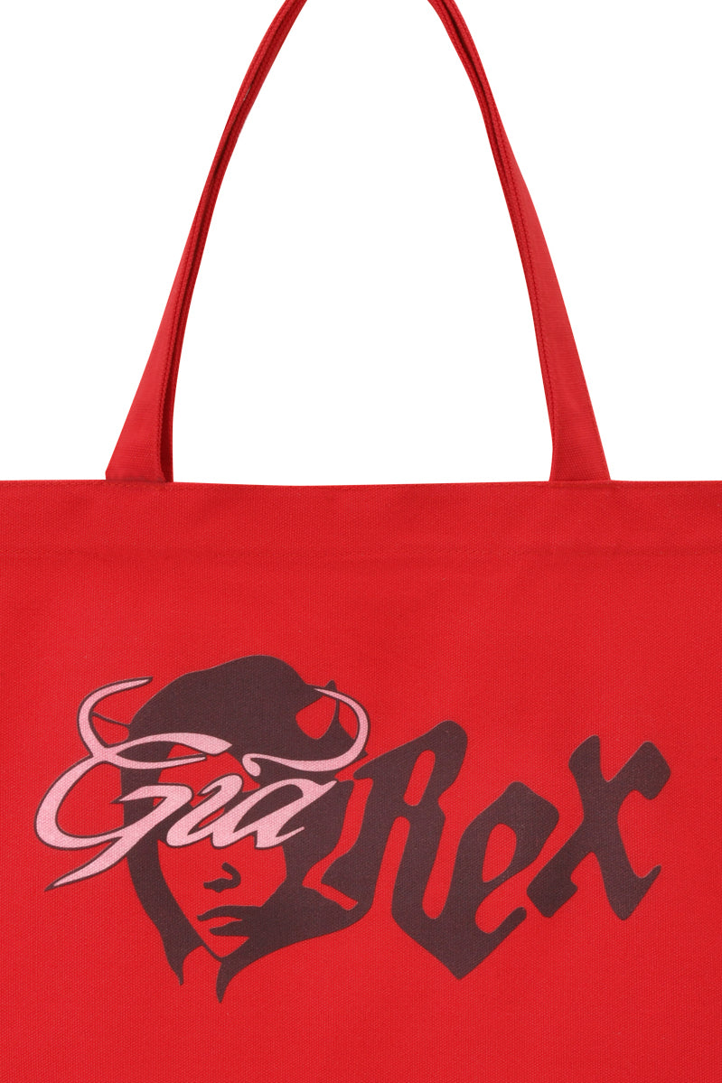The T-REX TOTE BAG - RED by I.AM.GIA features bold “Gal Rex” text and devil girl artwork—ideal as a laptop tote or standout everyday accessory.