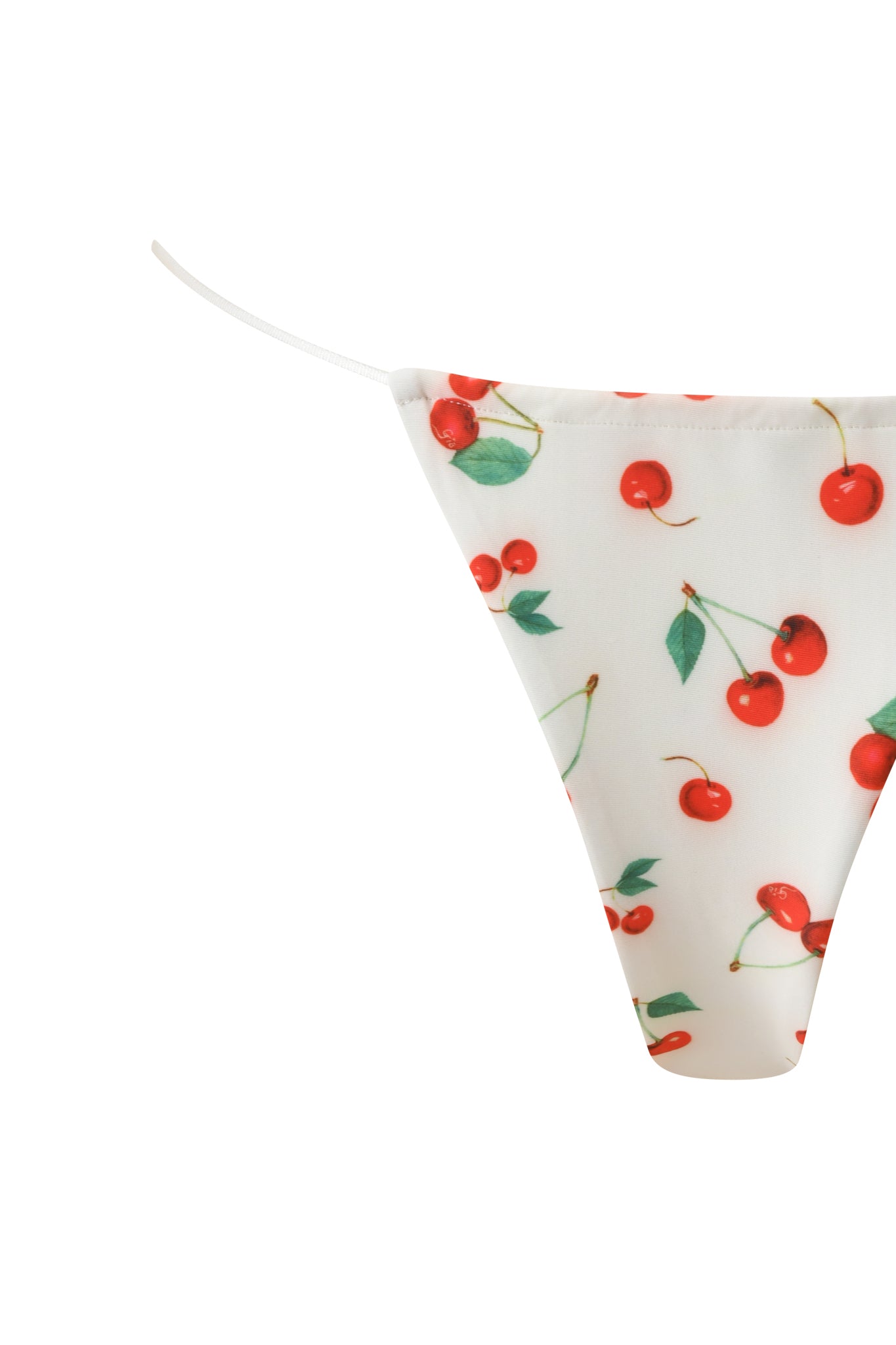 The BAMBI BIKINI BOTTOM - CHERRY ON TOP by I.AM.GIA features white thong styling with a vibrant cherry and green leaf print, thin side straps, and smooth fabric for a fun, cheeky bikini look.