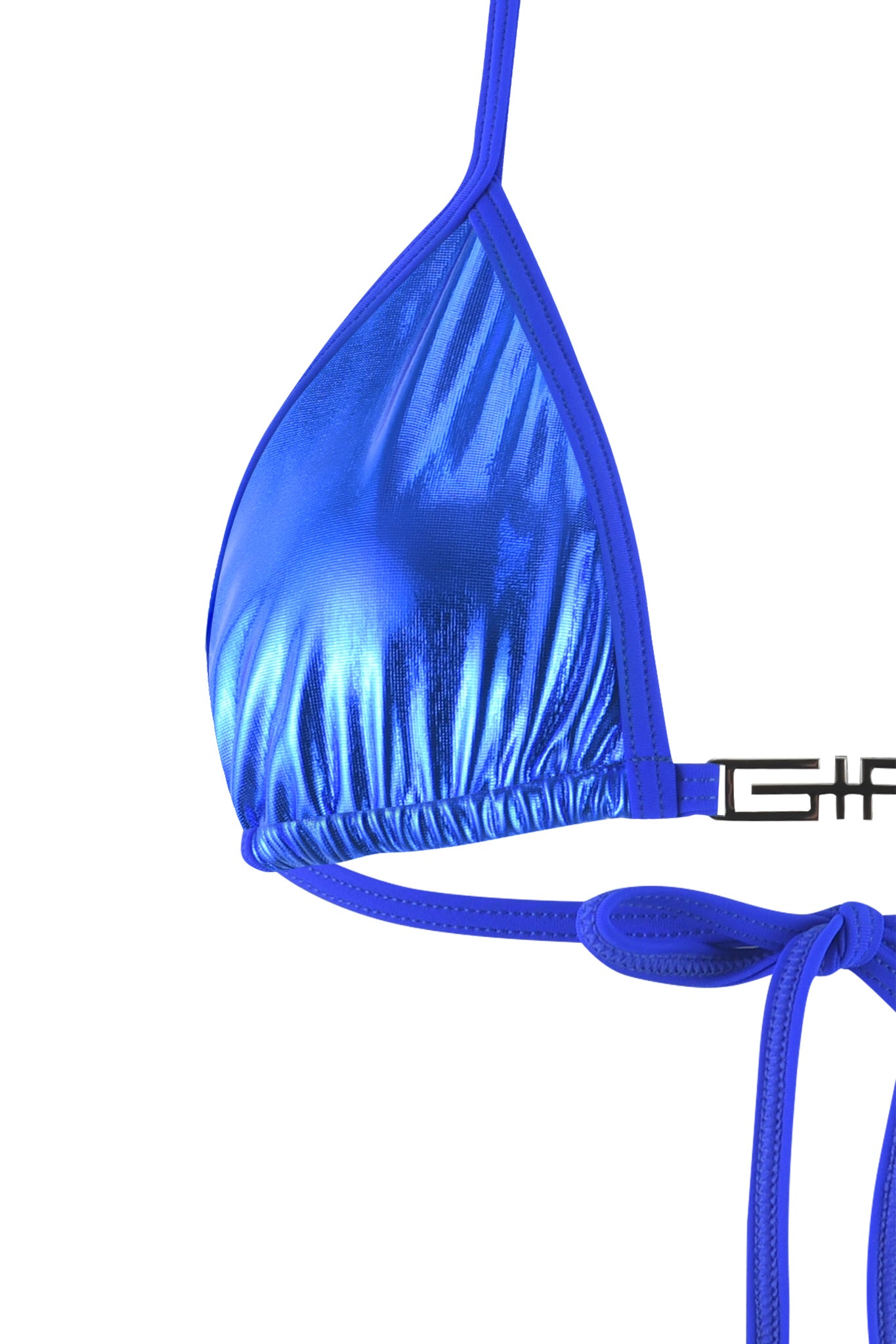 Close-up of the I.AM.GIA Alohi Bikini Top in cobalt blue with thin straps. The shiny, reflective metallic fabric features an adjustable true-tie halter neck at the bottom. One strap is seen going over the shoulder, and another tie is visible on the left side against a white background.