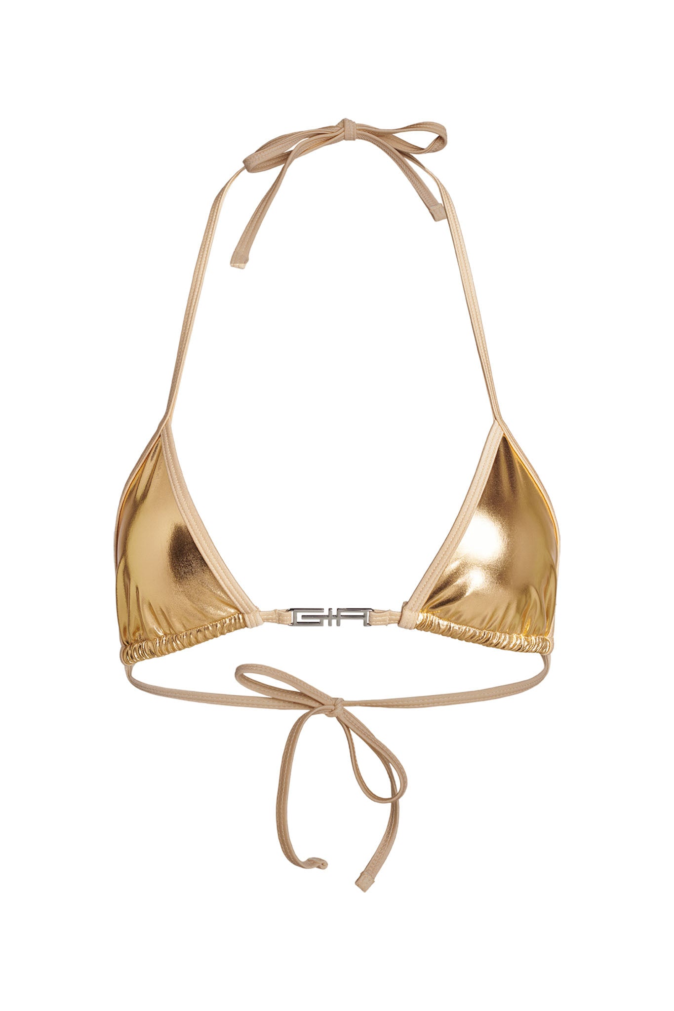 The ALOHI BIKINI TOP - GOLD by I.AM.GIA is a metallic gold triangle bikini top with thin beige straps. It features a halter-neck tie and a tie-back closure, along with a small metallic clasp detail at the front center connecting the two cups. The fabric boasts a shiny, reflective finish.