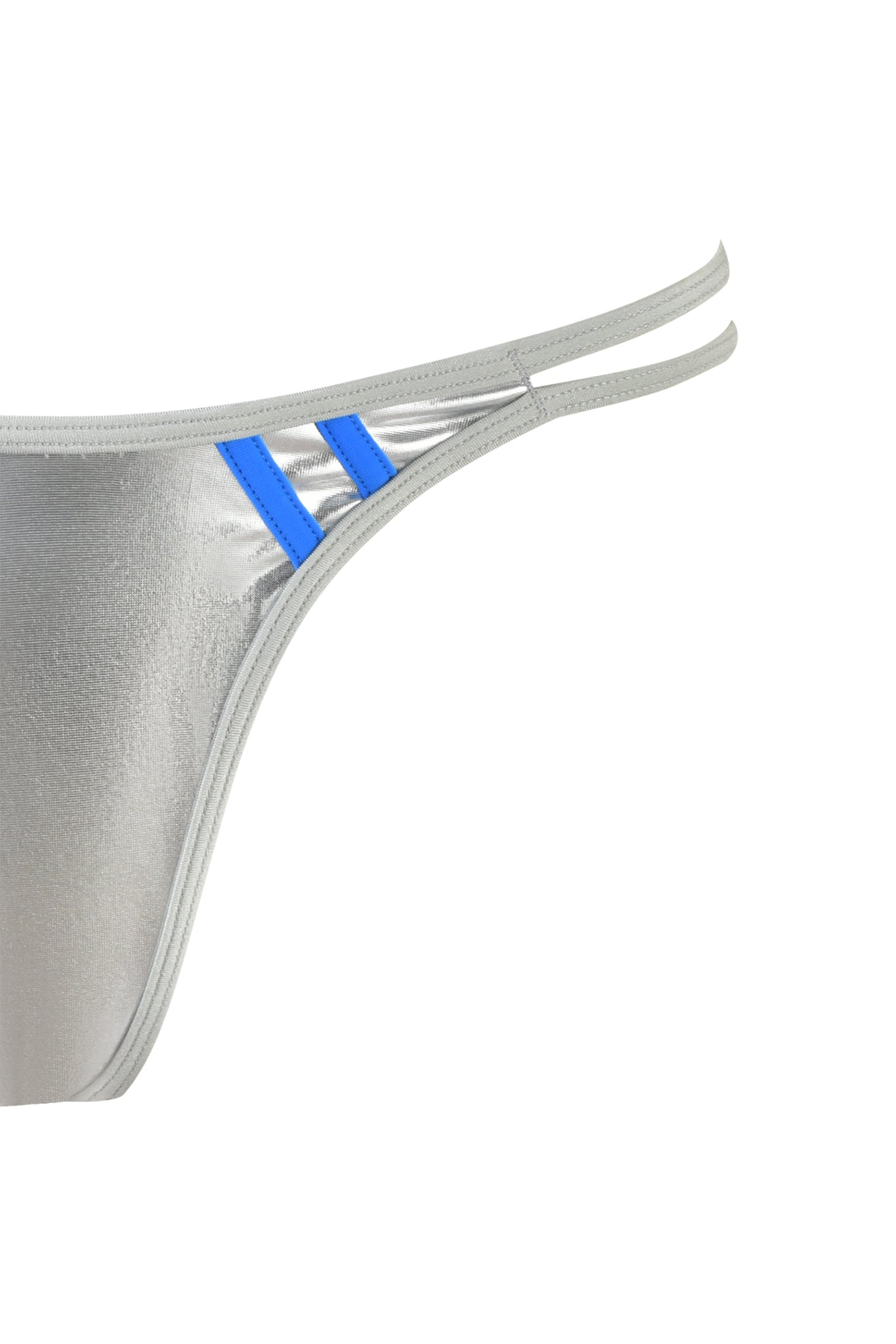 Close-up image of the HOLLY BIKINI BOTTOM - SILVER by I.AM.GIA, showcasing its metallic silver material with a shiny finish. The design includes double side straps and cheeky thong coverage. Two small blue stripes near the side straps are visible on the left side of the image, against a plain white background.