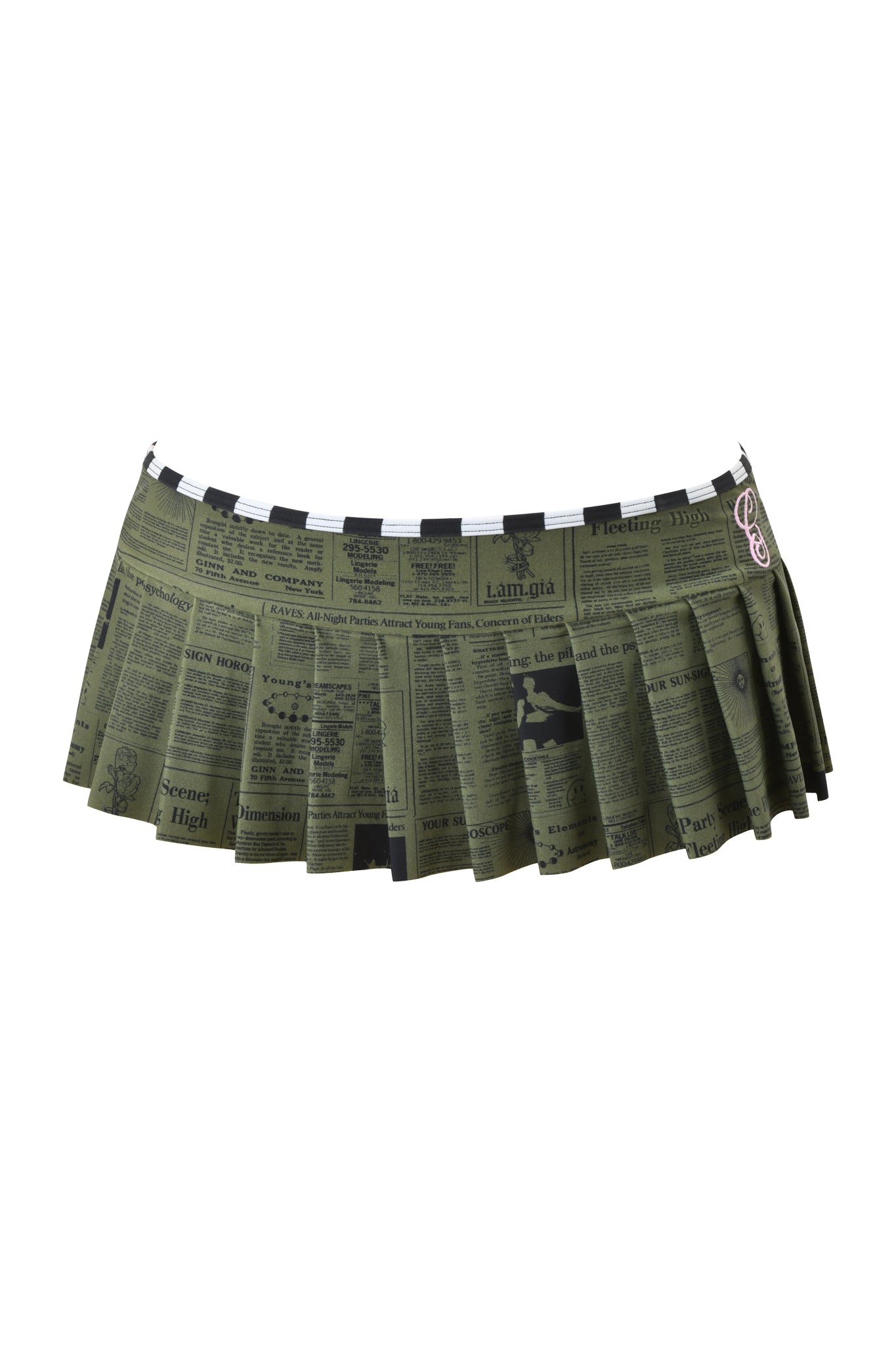 The I.AM.GIA AURETTE MICRO BIKINI SKIRT - LEFT ON READ features a dark green pleated micro mini design with an all-over black newspaper print in bold headlines and varied fonts.