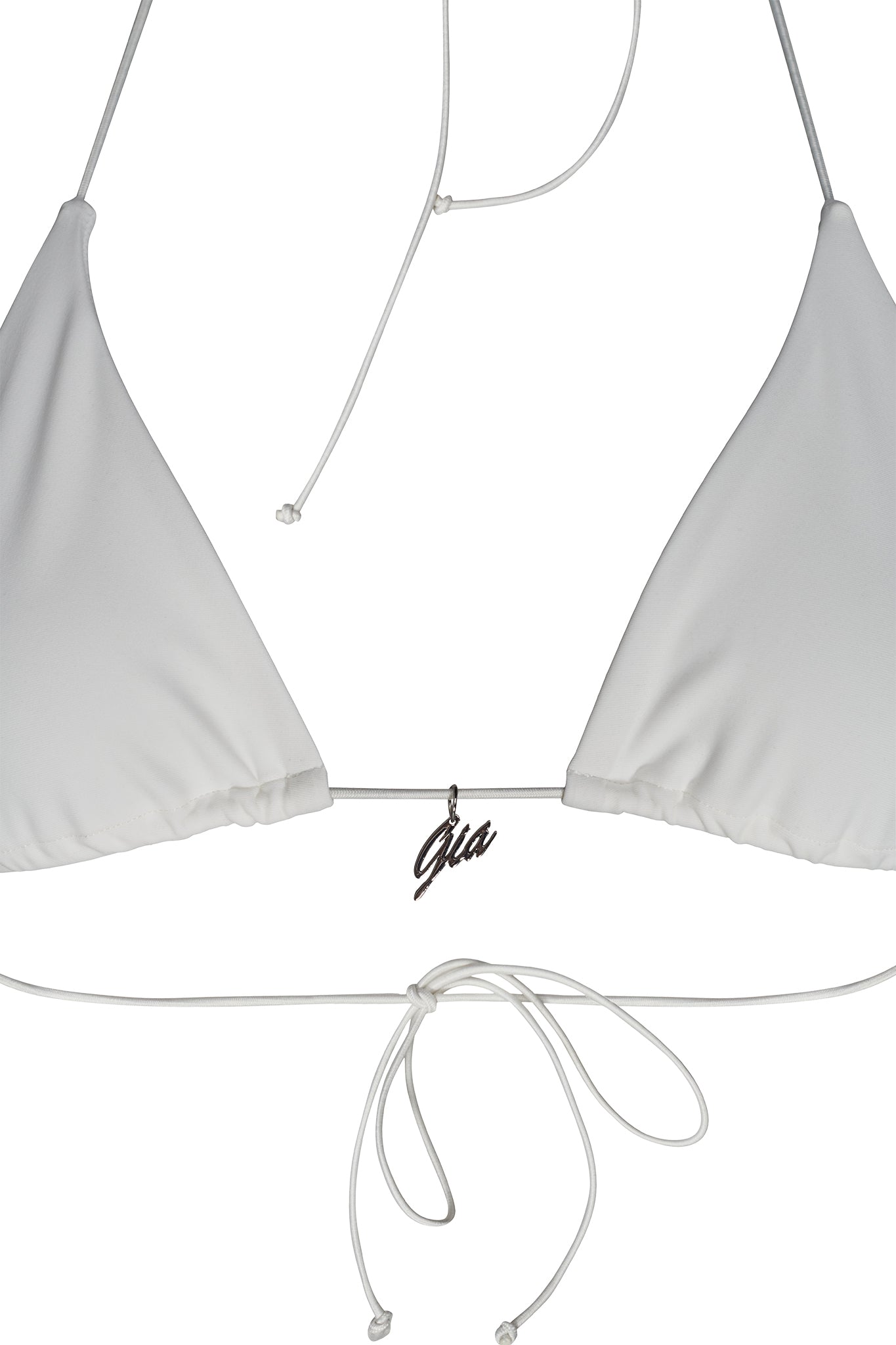 The BAMBI BIKINI TOP - WHITE from the I.AM.GIA collection is a white triangle bikini top with thin straps tied at the back and neck, featuring a small silver cursive pendant engraved with "Gia." The fabric is smooth and minimalist in design.
