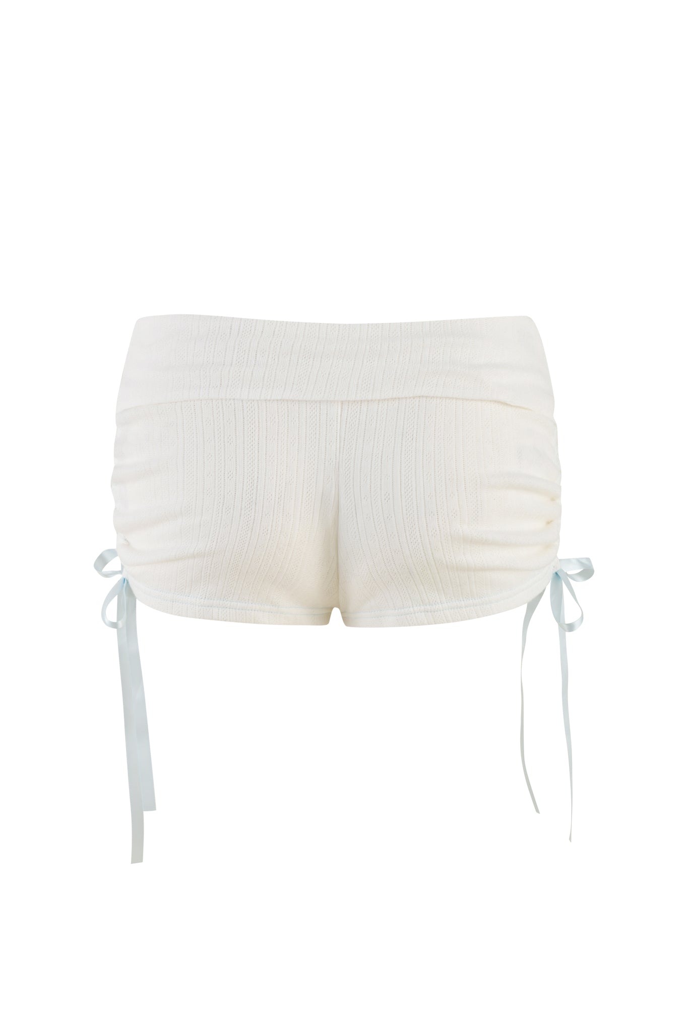 The MIA SHORT - WHITE by I.AM.GIA is a pair of high-waisted, bodycon shorts with a ribbed texture and side ruching. Light blue ribbons are tied into bows at the sides, adding a decorative touch to these soft, stretchy knit shorts.
