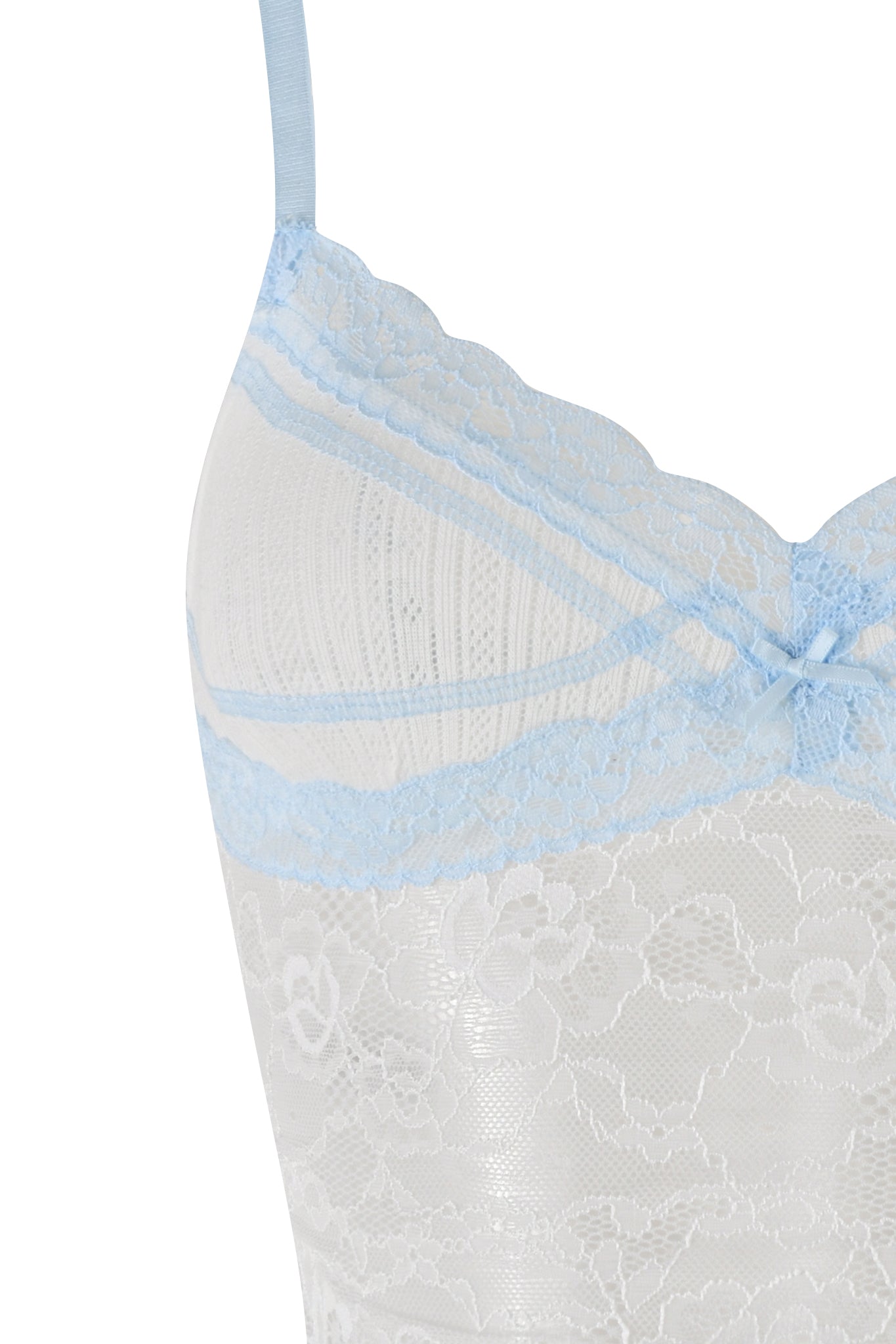 Here is a close-up image of the SERINA TANK - WHITE by I.AM.GIA. This white lace camisole showcases intricate floral stretch lace patterns, adorned with blue lace detailing along the neckline and a small blue bow at the center, at the top of the camisole.