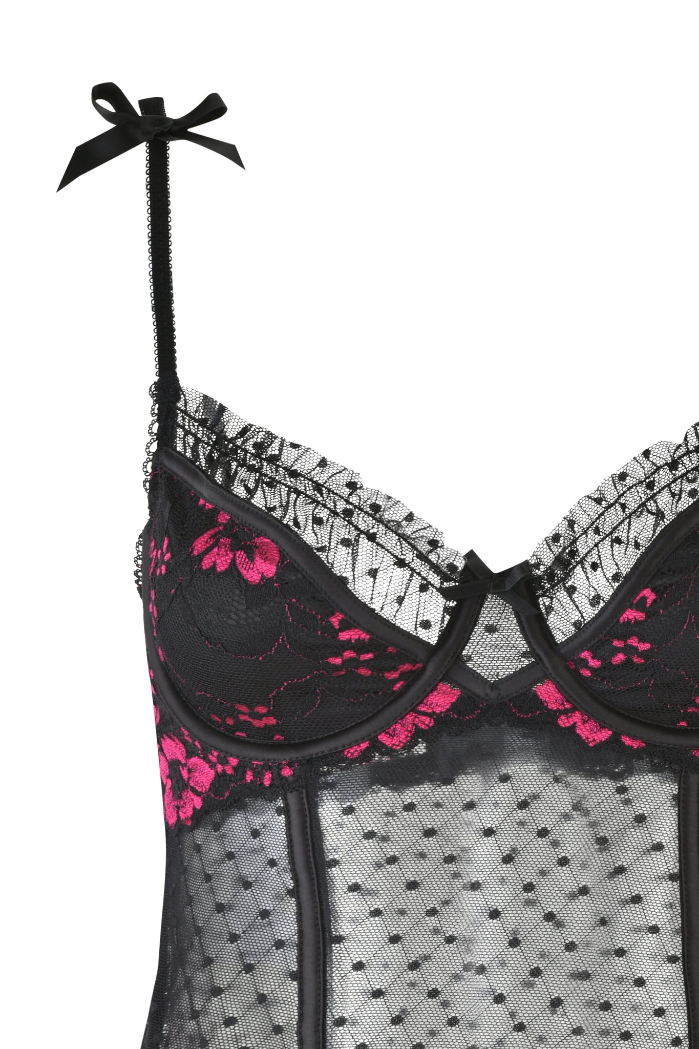 A close-up of the AMBROSE BUSTIER SET - BLACK by I.AM.GIA reveals a sheer black top with pink floral lace, ruffled trim, adjustable straps with bows, and a delicate polka dot pattern. It pairs perfectly with a low-rise g-string for an alluring look.