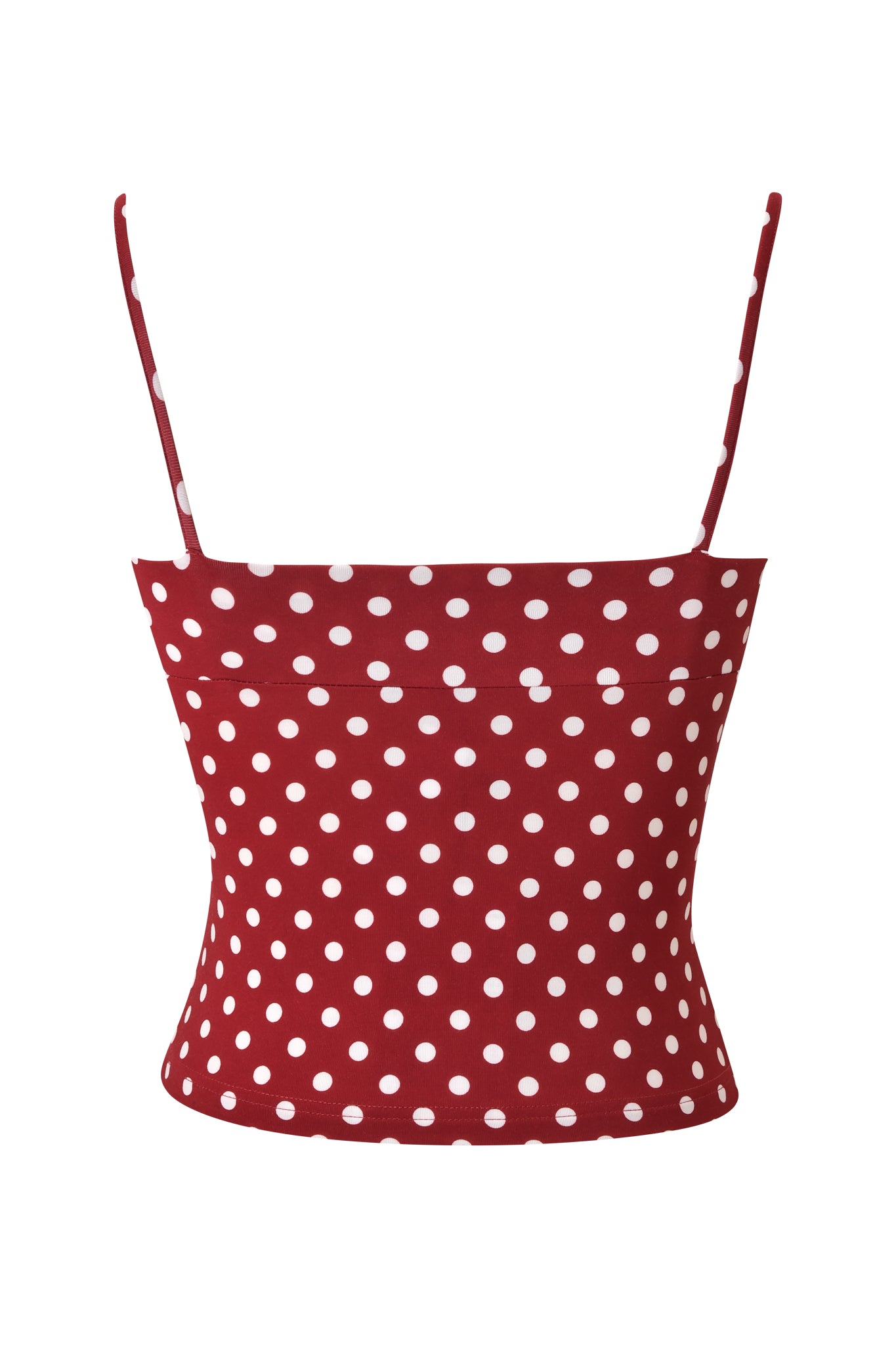 The MELANIE CAMI - RED POLKA DOT by I.AM.GIA is a red polka dot crop top with a bodycon fit, thin adjustable straps, and a sleeveless design, shown against a plain white background.