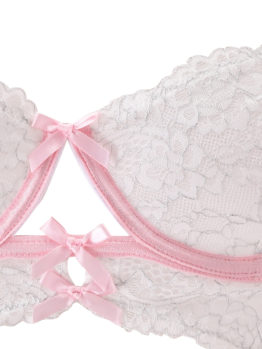 Close-up of the BUNNY LINGERIE SET - WHITE PINK by I.AM.GIA, featuring a lacy white bra with pink trim and three small pink ribbons. The floral lace details and central decorative keyhole cutout capture the delicate charm and vintage-inspired style of this timeless lingerie set.