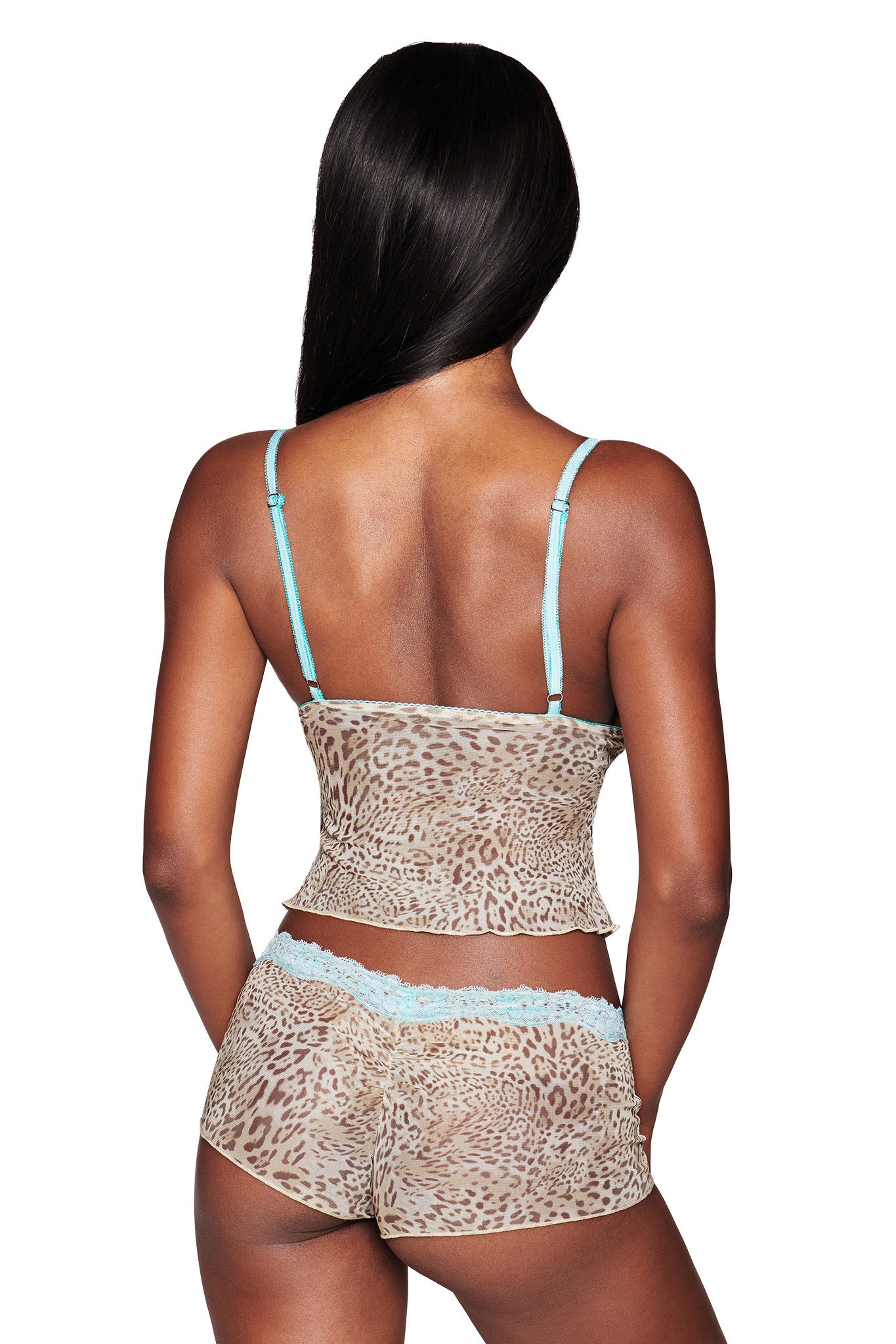 A woman with long, straight black hair is shown from behind wearing the I.AM.GIA TASHA SHORT - LEOPARD LIMBO set, a leopard print mesh camisole and hot shorts with aqua blue lace trim, standing out against a white background.
