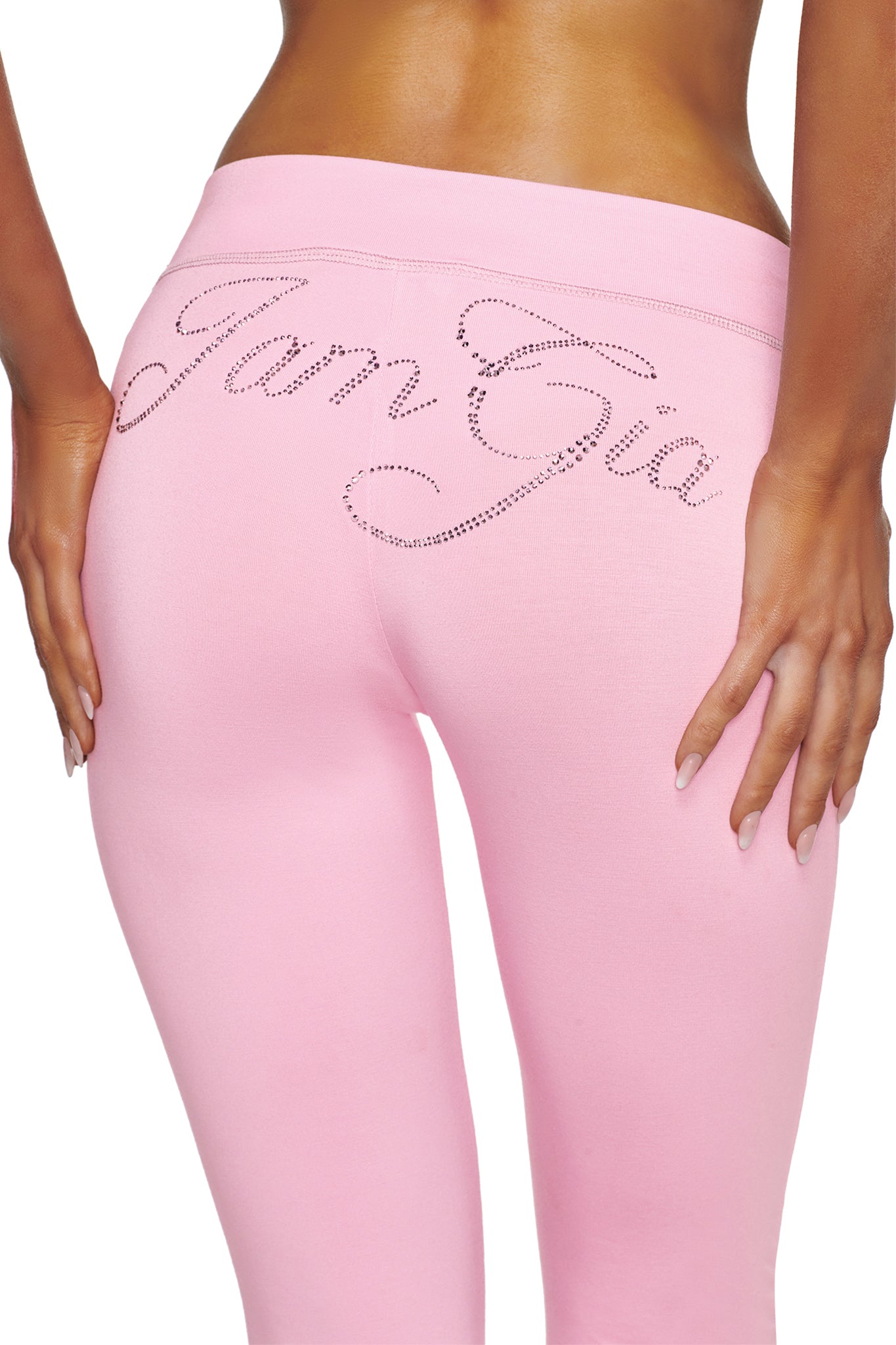 A person shown from behind wearing the I.AM.GIA BLARE LOW RISE DIAMONTE CAPRI in baby pink, featuring rhinestone “I.AM.GIA” lettering across the back.