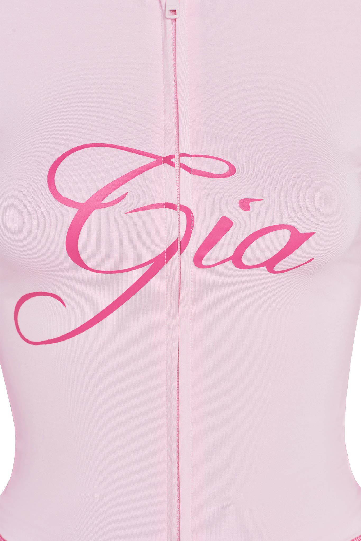 Close-up of the "BLARE HOODIE - PINK : PASTEL PINK" by I.AM.GIA. featuring an elegant "Gia" script across the chest area in large, stylish pink letters. The hoodie boasts a visible central seam running vertically down the front and is made from smooth, slightly stretchy bamboo fabric that offers a sophisticated yet comfortable feel.