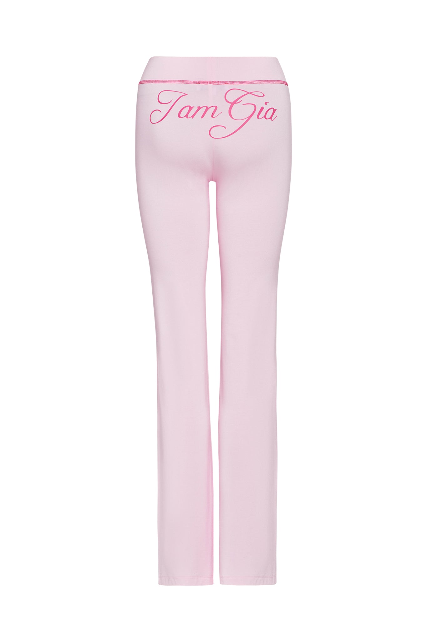 A pair of pastel pink Blare Trackpants from I.AM.GIA displayed from the back, featuring "IamGia" in cursive across the waistband area. Made from stretchy bamboo fabric, these pants have a fitted style that flares slightly at the hem.