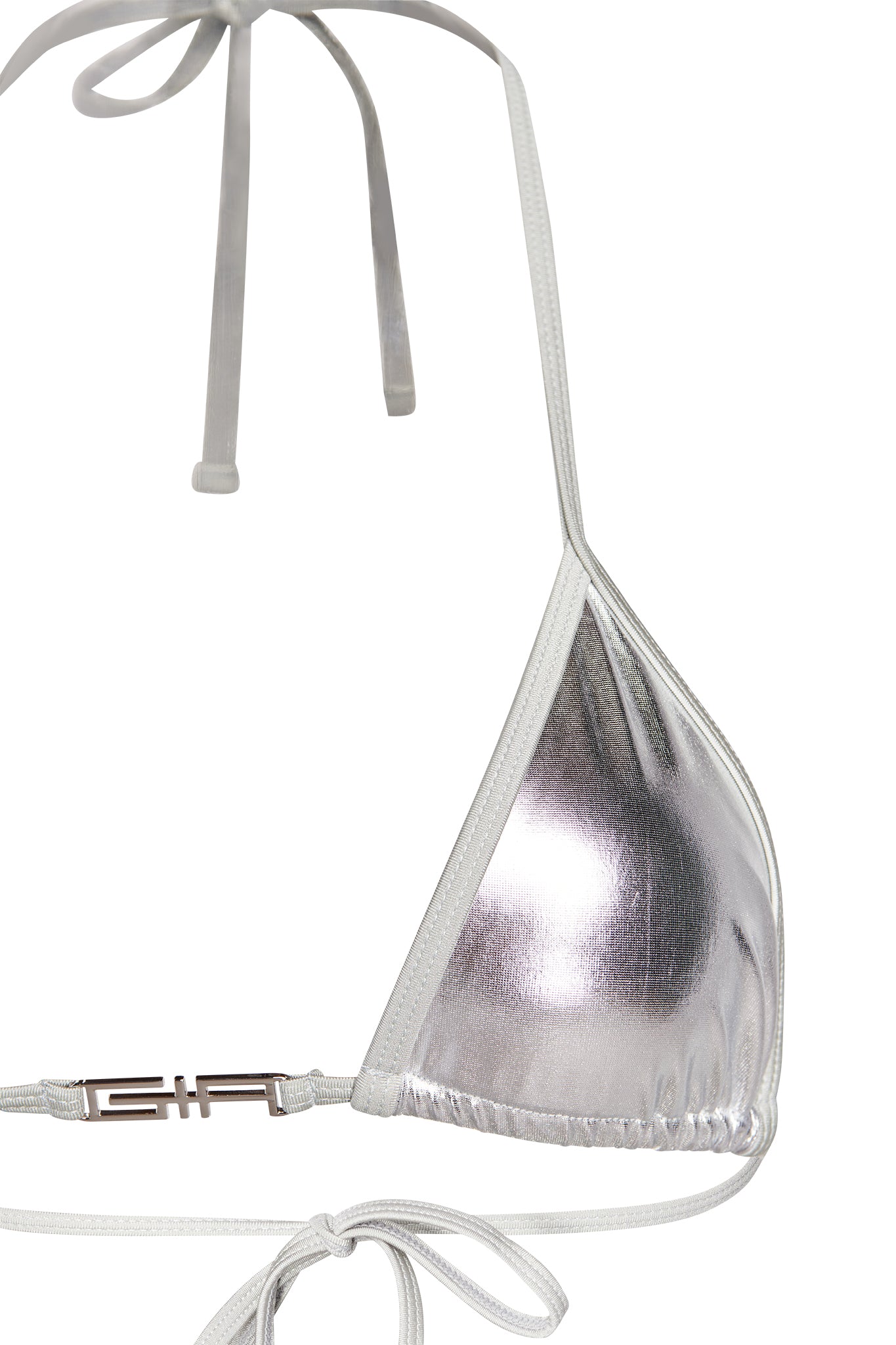 Close-up of the ALOHI BIKINI TOP - GREY : SILVER by I.AM.GIA, showcasing its halter neck and secure tie. This silver metallic bikini top features a clasp band adorned with a metallic rectangular logo detail, enhancing the minimal design with a touch of elegance. The fabric appears shiny and reflective.