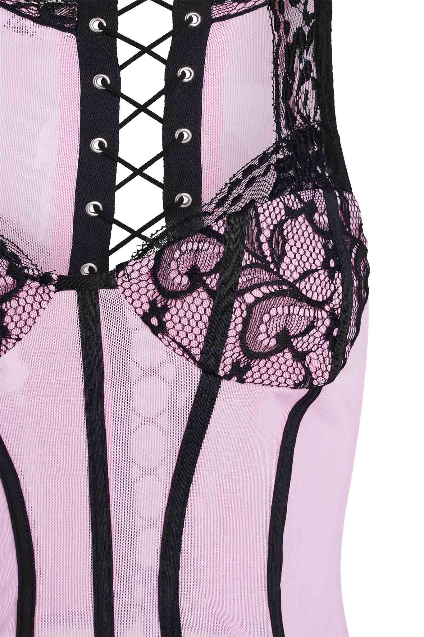 Close-up of the SUTRA CORSET - PINK by I.AM.GIA, featuring black lace detailing that’s synonymous with the brand's signature style. The corset showcases black laces threading through eyelets along the chest area, forming a crisscross pattern. Additionally, black vertical boning and intricate floral lace embellishments add an elegant touch to this stylish piece.