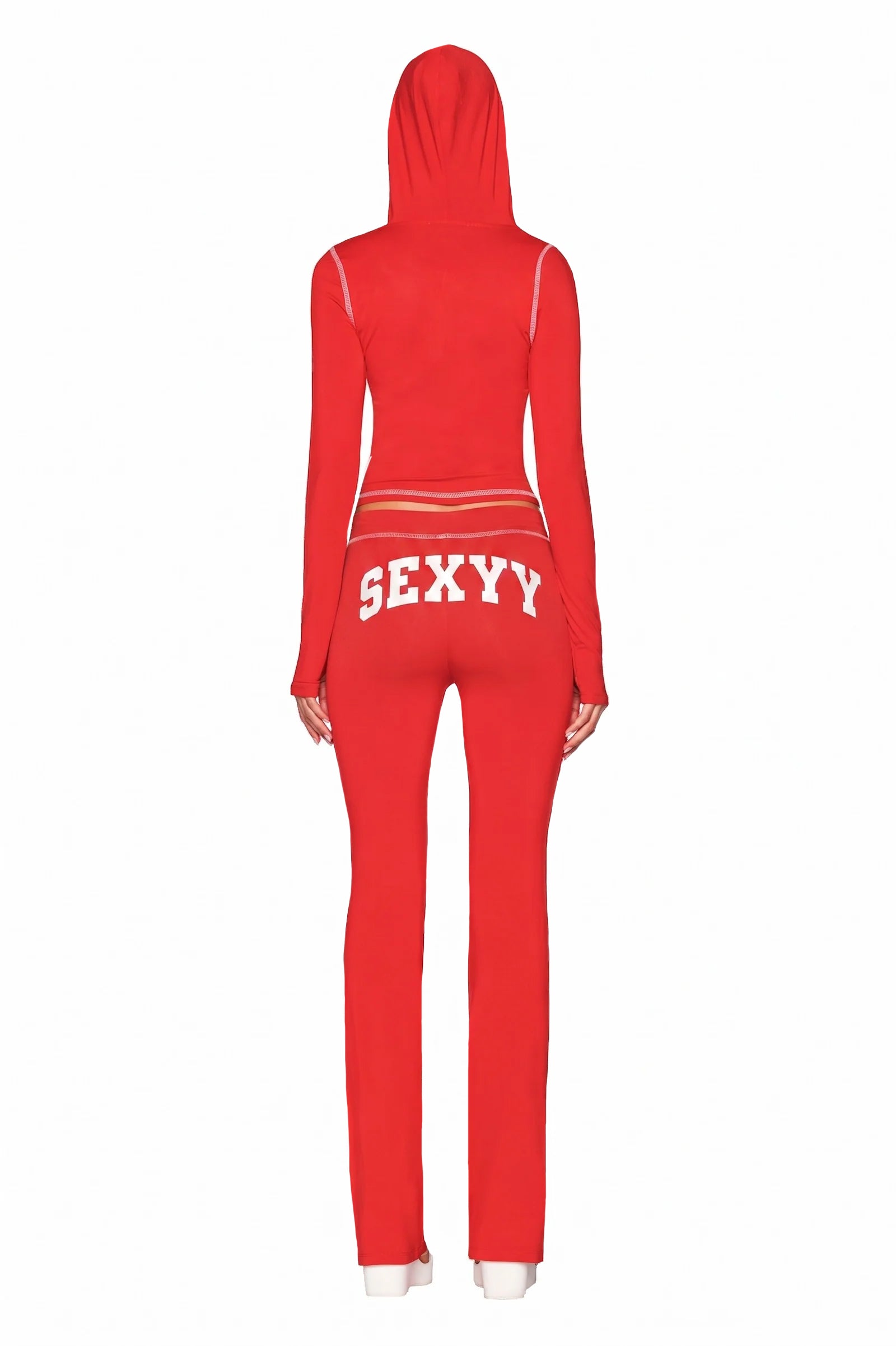 Wearing the I.AM.GIA X SEXYY RED BLARE HOODIE - RED and matching flared pants with "SEXXY" on the back, a person poses in long sleeves against a plain white background.