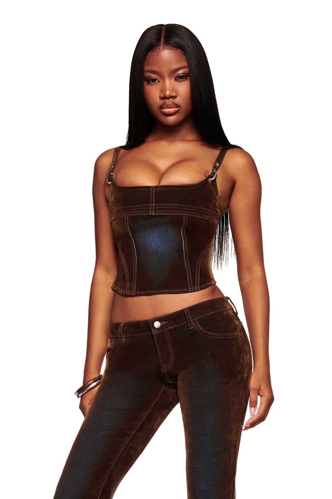 A woman with long, straight black hair wears the I.AM.GIA VIVAINE DENIM CORSET TOP in neutral, styled with matching pants in a vintage brushed look. She stands confidently against a plain white background.