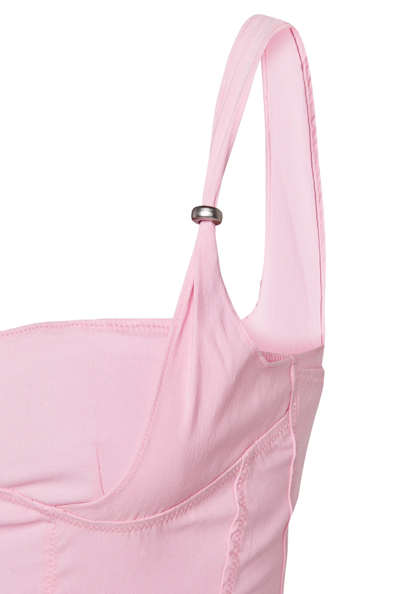 Close-up of the IDEZ CORSET - PINK by I.AM.GIA, showcasing its adjustable pastel pink straps. The soft fabric is slightly gathered at the seam, with one strap featuring an adjustable silver ring for a customizable fit. The visible stitching details lend the garment a tailored and refined appearance.