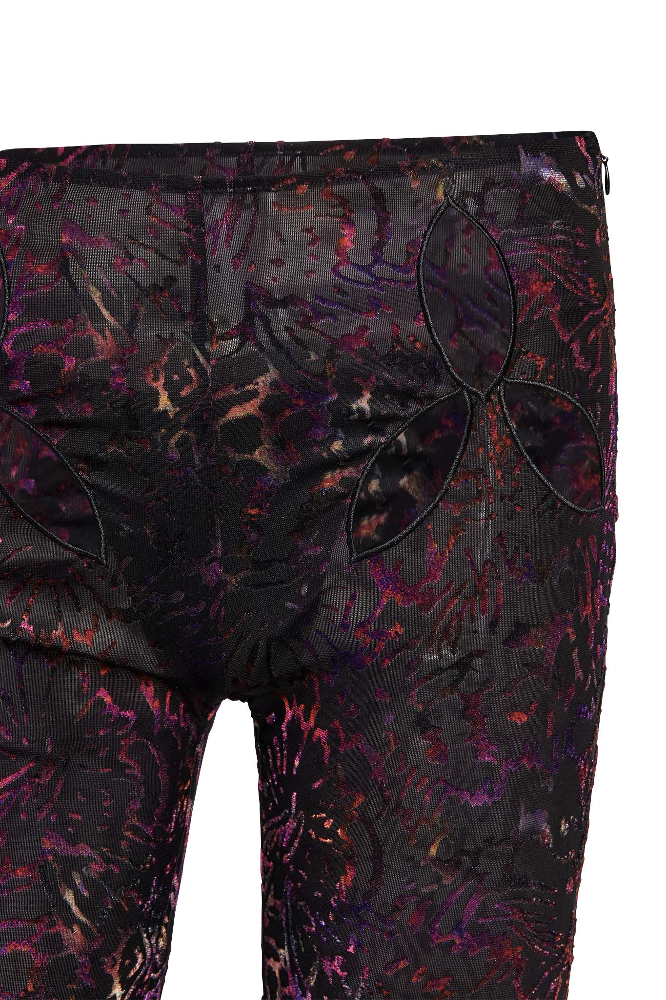 A close-up of a pair of I.AM.GIA's AMINA PANT - ANIMAL BURN OUT, showcasing a striking abstract floral pattern in shades of red, purple, and black. The pants feature intricate cutout details in the shape of petals near the hip area, with a texture that combines both sheer and solid fabrics.